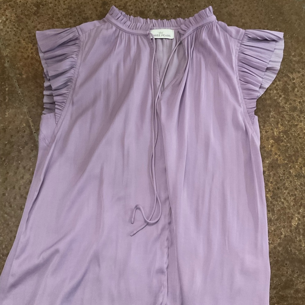Cute lavender top with detailed sleeve. Size S